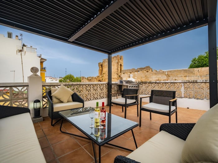 Comfortable sofas and armchairs around coffee table on the solarium